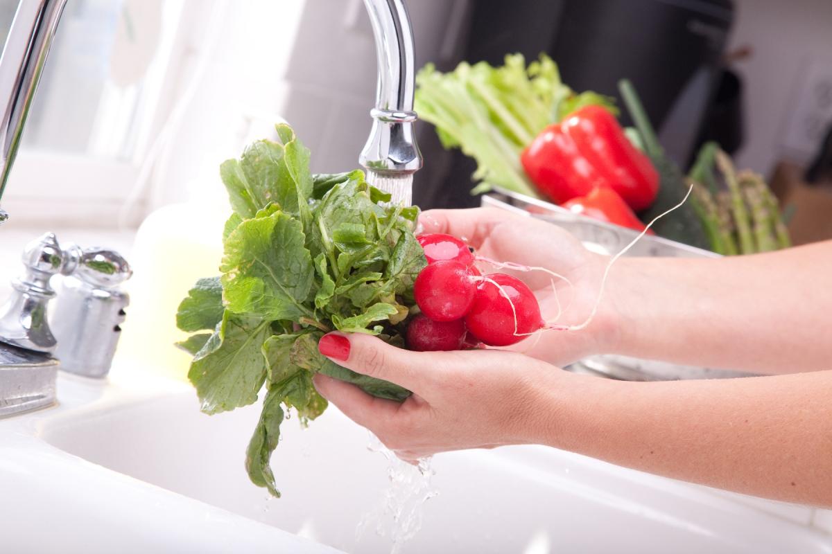 Washing veggies in the kitchen sink